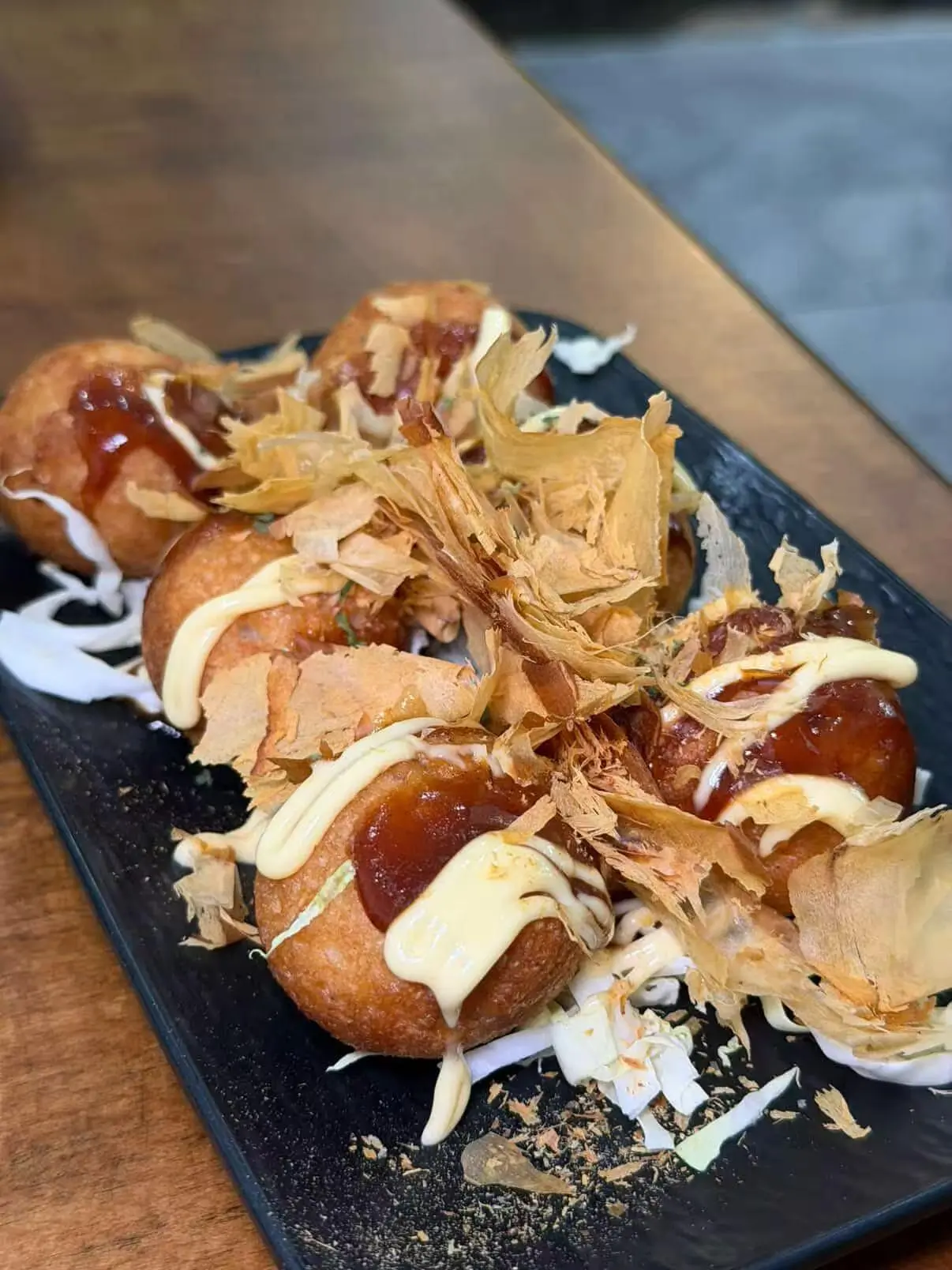 Takoyaki octopus balls with mayo, sauce and bonito flakes at Akagi, a Japanese restaurant in Rockville
